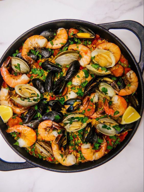 Which country does the delicious Seafood paella come from?